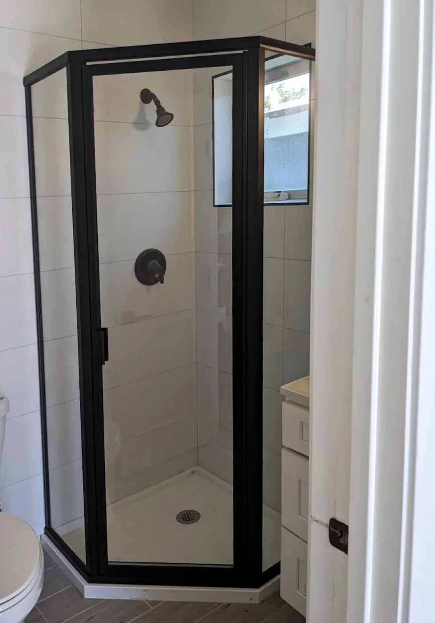 Black framed neo-angle glass shower enclosure
